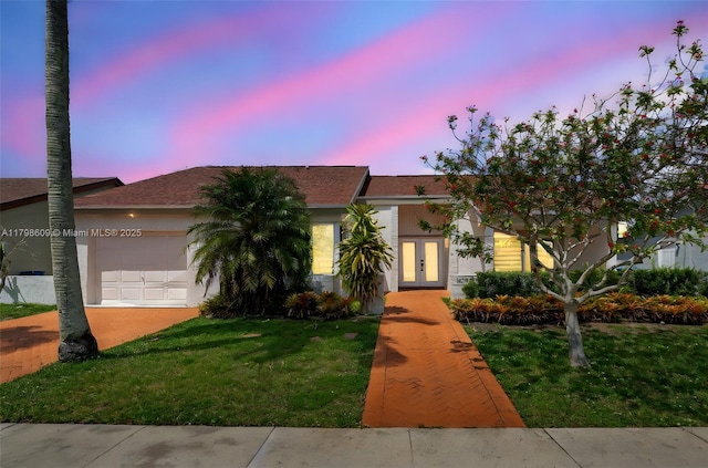 16791 Royal Poinciana Dr, Weston, FL 33326 - view of front of property featuring french doors, an attached garage, a front yard, and stucco siding