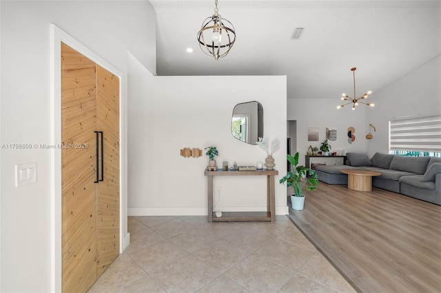 16791 Royal Poinciana Dr, Weston, FL 33326 - foyer featuring a chandelier, light tile patterned flooring, lofted ceiling, and baseboards