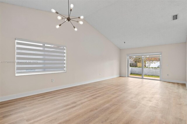 16791 Royal Poinciana Dr, Weston, FL 33326 - unfurnished room with a chandelier, wood finished floors, baseboards, and high vaulted ceiling