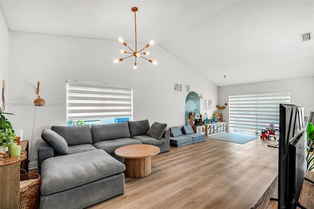 16791 Royal Poinciana Dr, Weston, FL 33326 - living area with plenty of natural light, wood finished floors, a chandelier, and high vaulted ceiling