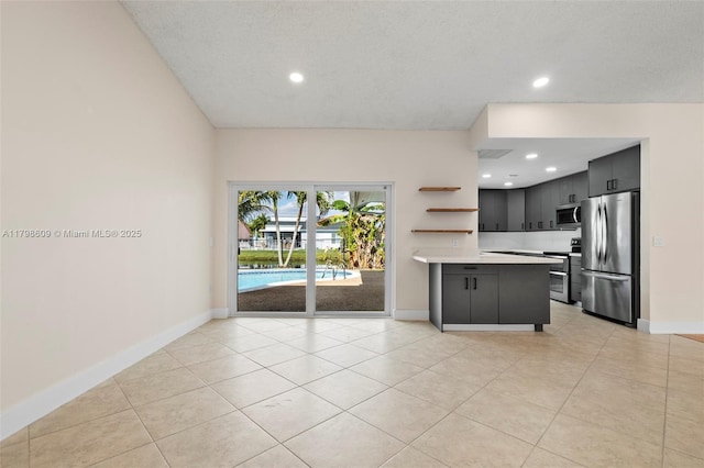 16791 Royal Poinciana Dr, Weston, FL 33326 - kitchen with stainless steel appliances, light countertops, a peninsula, baseboards, and recessed lighting