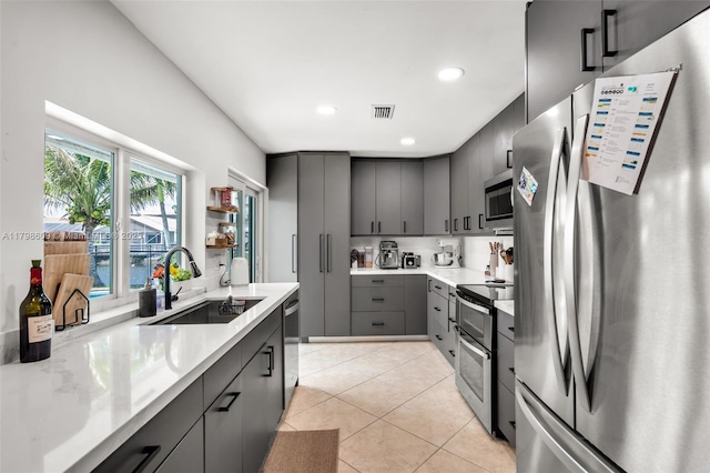 16791 Royal Poinciana Dr, Weston, FL 33326 - kitchen with stainless steel appliances, a sink, gray cabinetry, light tile patterned flooring, and recessed lighting