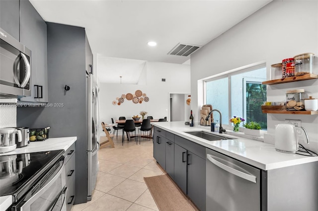 16791 Royal Poinciana Dr, Weston, FL 33326 - kitchen featuring a sink, appliances with stainless steel finishes, light countertops, light tile patterned floors, and gray cabinets