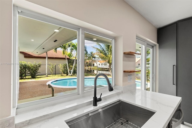 16791 Royal Poinciana Dr, Weston, FL 33326 - kitchen featuring a sink, light stone countertops, and open shelves