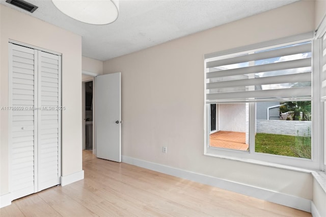 16791 Royal Poinciana Dr, Weston, FL 33326 - unfurnished bedroom with light wood-type flooring, baseboards, and a closet