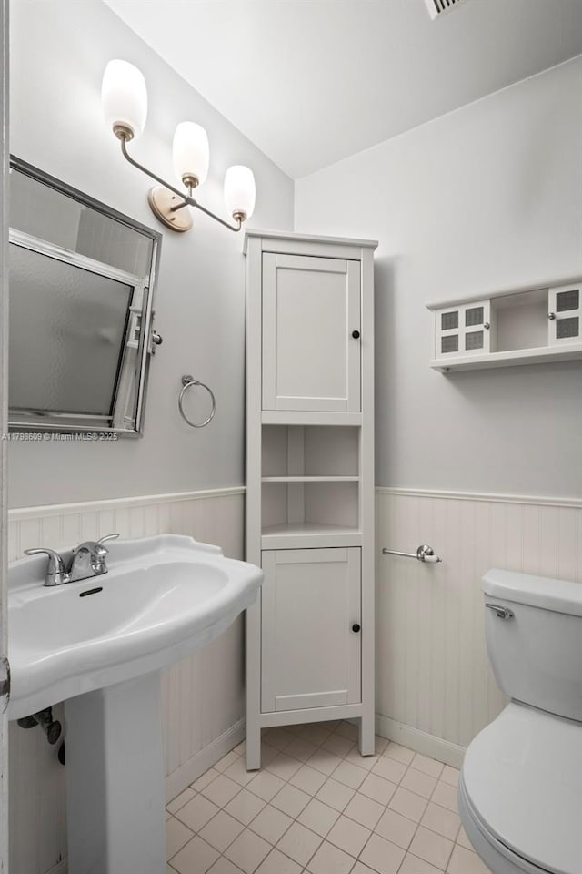 16791 Royal Poinciana Dr, Weston, FL 33326 - bathroom with a wainscoted wall, tile patterned flooring, toilet, and a sink