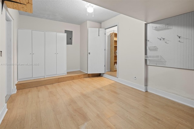 16791 Royal Poinciana Dr, Weston, FL 33326 - unfurnished bedroom featuring light wood-type flooring, baseboards, electric panel, and a closet