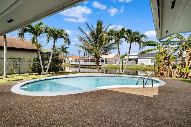 16791 Royal Poinciana Dr, Weston, FL 33326 - view of swimming pool with a fenced backyard, a water view, a residential view, and a patio area