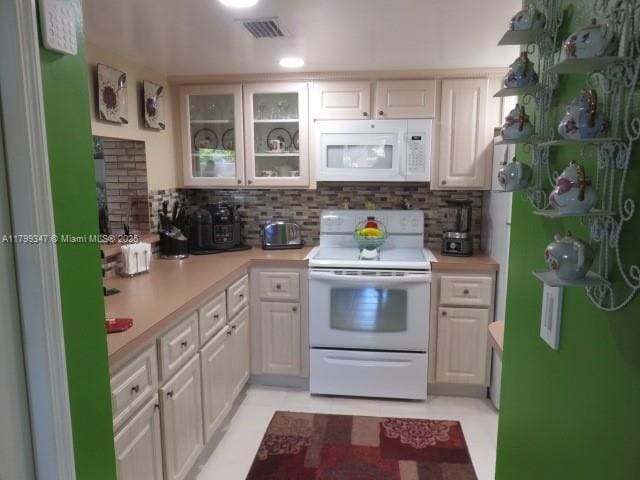 7040 SW 24th St Unit 104, Miami, FL 33155 - kitchen featuring white appliances, light countertops, decorative backsplash, and glass insert cabinets