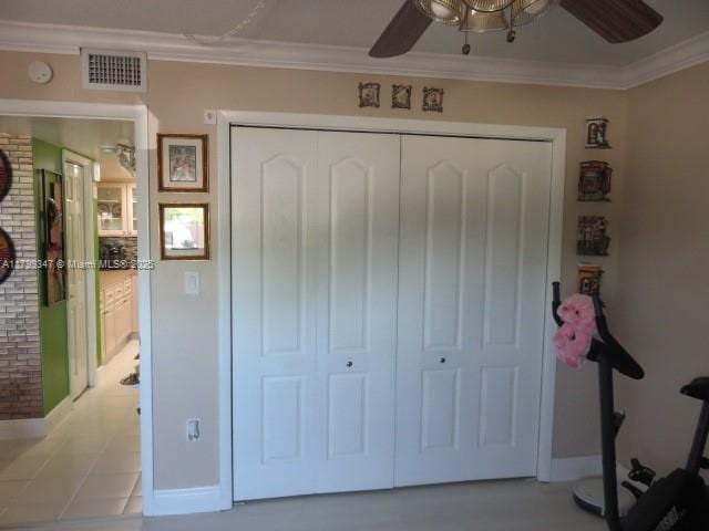 7040 SW 24th St Unit 104, Miami, FL 33155 - bedroom featuring a closet, crown molding, baseboards, and ceiling fan