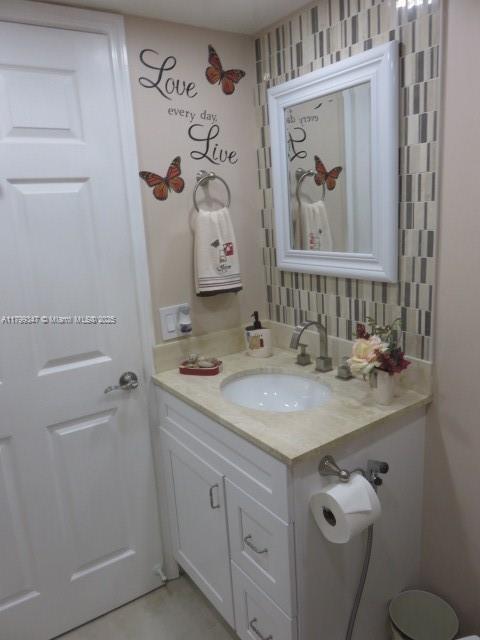 7040 SW 24th St Unit 104, Miami, FL 33155 - bathroom with vanity and decorative backsplash