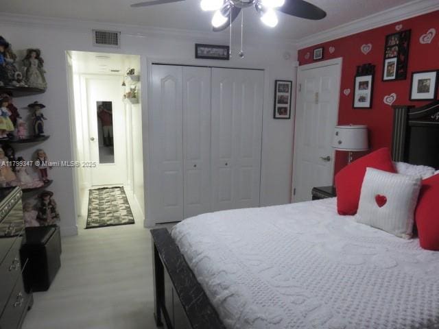 7040 SW 24th St Unit 104, Miami, FL 33155 - bedroom with a closet, a ceiling fan, crown molding, and light flooring