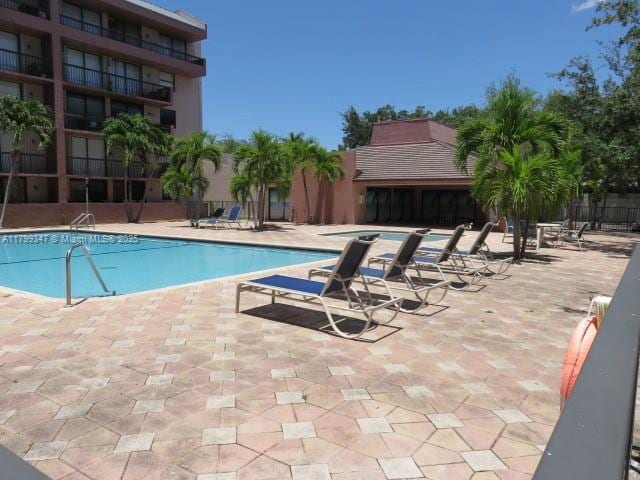 7040 SW 24th St Unit 104, Miami, FL 33155 - community pool featuring a patio area and fence