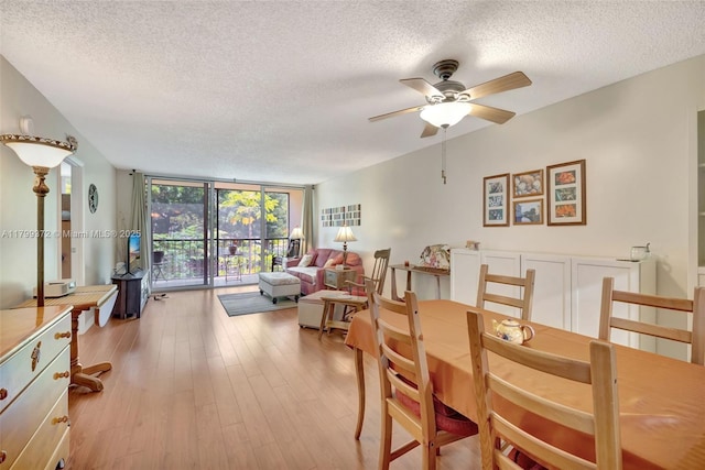 7080 Environ Blvd Unit 223, Lauderhill, FL 33319 - dining room with a textured ceiling, floor to ceiling windows, ceiling fan, and light wood finished floors