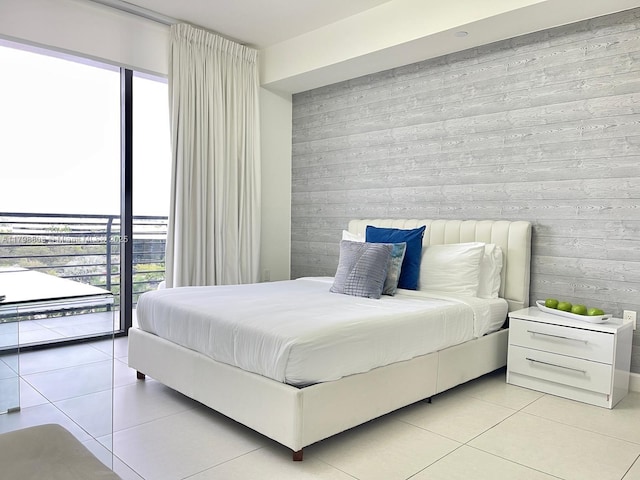 bedroom featuring light tile patterned floors and access to exterior