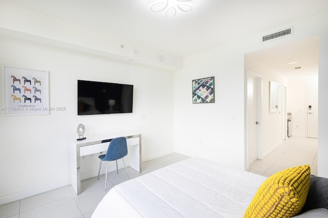bedroom with tile patterned flooring, an office area, and baseboards