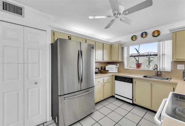 10451 Sunrise Lakes Blvd Unit 205, Sunrise, FL 33322 - kitchen featuring white appliances, cream cabinetry, light countertops, a ceiling fan, and light tile patterned flooring
