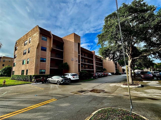 10451 Sunrise Lakes Blvd Unit 205, Sunrise, FL 33322 - view of apartment building / complex featuring uncovered parking