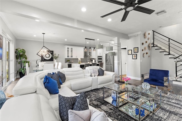 living room featuring stairs, a ceiling fan, baseboards, recessed lighting, and wood finished floors