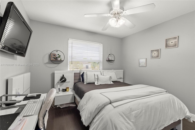 bedroom with wood finished floors, a ceiling fan, and an office area