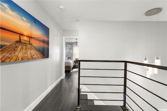 hallway with wood finished floors and baseboards