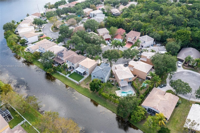 aerial view of property and surrounding area with nearby suburban area and a nearby body of water