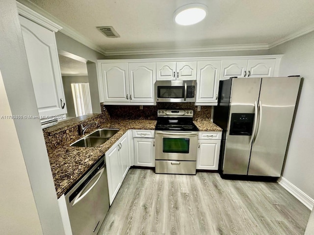 15711 SW 137th Ave Unit 201, Miami, FL 33177 - kitchen with stainless steel appliances, a sink, light wood finished floors, white cabinetry, and crown molding