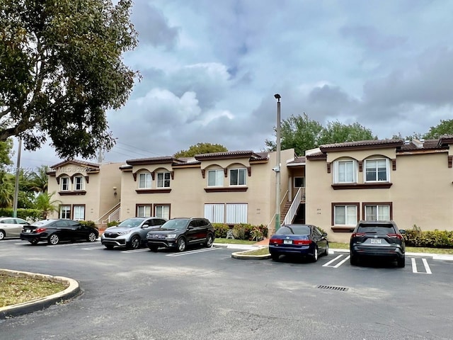 15711 SW 137th Ave Unit 201, Miami, FL 33177 - view of property featuring uncovered parking and stairway