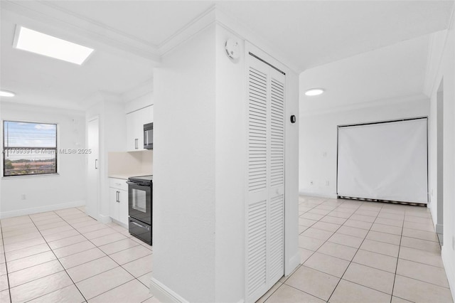 8401 NW 8th St Unit 401, Miami, FL 33126 - kitchen featuring black electric range, light tile patterned flooring, white cabinetry, crown molding, and light countertops