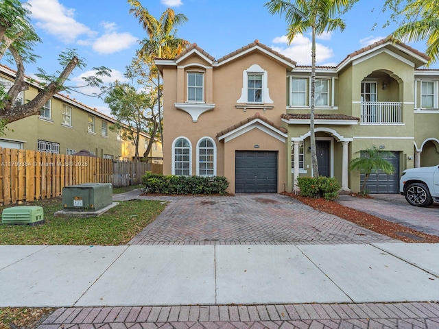 2482 SE 14th Ct, Homestead, FL 33035 - townhome / multi-family property with an attached garage, stucco siding, a tile roof, and decorative driveway