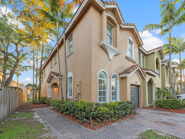 2482 SE 14th Ct, Homestead, FL 33035 - view of property exterior with a tile roof, stucco siding, and fence
