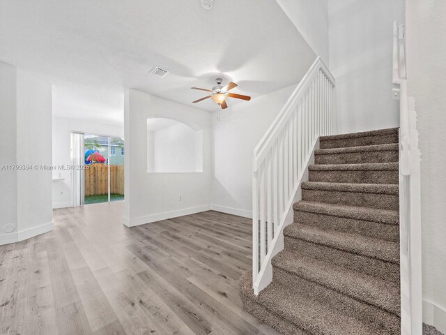 2482 SE 14th Ct, Homestead, FL 33035 - staircase with wood finished floors, a ceiling fan, and baseboards