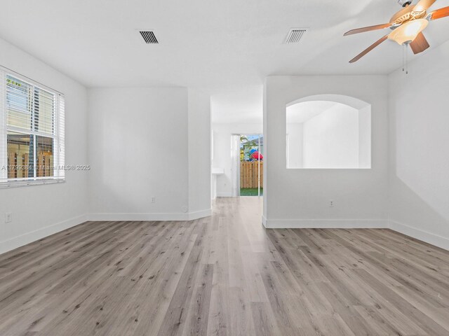 2482 SE 14th Ct, Homestead, FL 33035 - empty room featuring wood finished floors, healthy amount of natural light, baseboards, and a ceiling fan