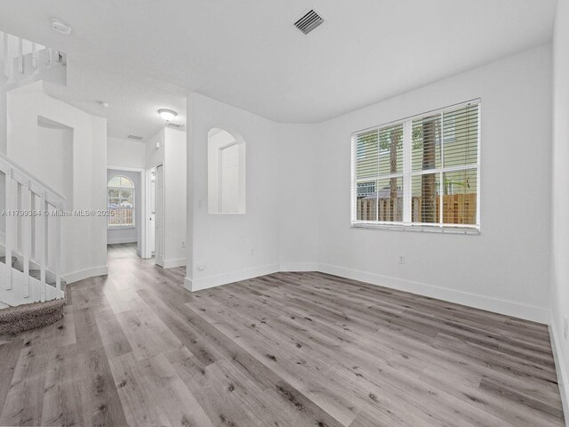 2482 SE 14th Ct, Homestead, FL 33035 - unfurnished living room featuring stairway, wood finished floors, and baseboards
