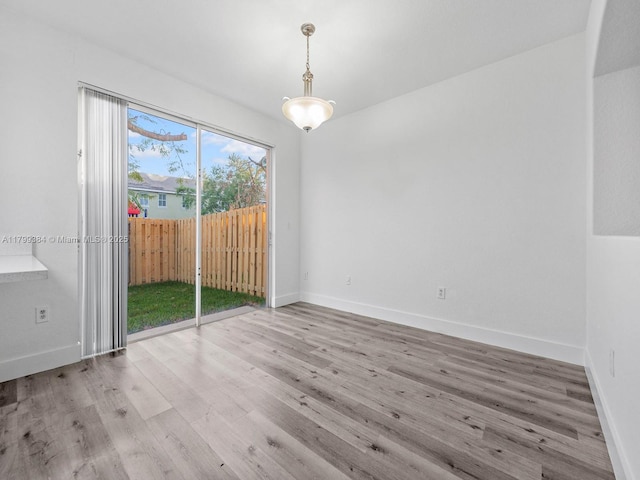 2482 SE 14th Ct, Homestead, FL 33035 - unfurnished dining area featuring wood finished floors and baseboards