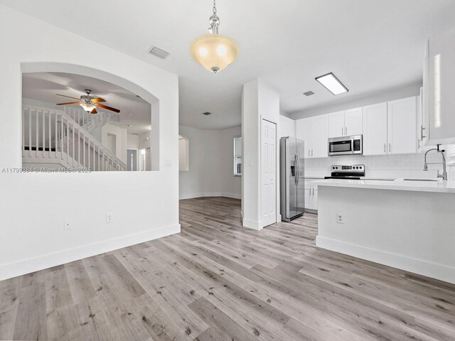 2482 SE 14th Ct, Homestead, FL 33035 - kitchen with stainless steel appliances, a sink, light countertops, backsplash, and a ceiling fan