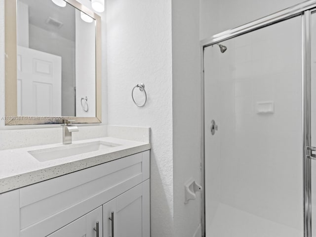 2482 SE 14th Ct, Homestead, FL 33035 - full bathroom with a stall shower, vanity, and a textured wall