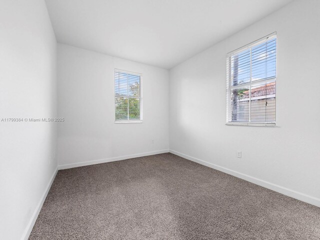 2482 SE 14th Ct, Homestead, FL 33035 - spare room featuring carpet floors and baseboards