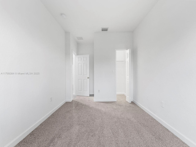 2482 SE 14th Ct, Homestead, FL 33035 - unfurnished bedroom with carpet flooring, baseboards, a closet, and a walk in closet