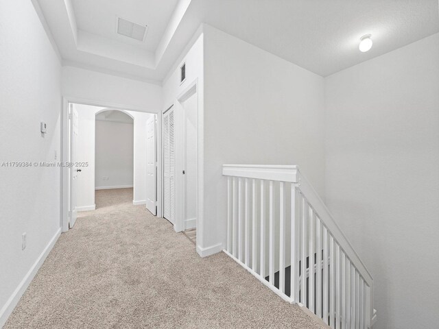 2482 SE 14th Ct, Homestead, FL 33035 - hall with carpet floors, an upstairs landing, arched walkways, and baseboards