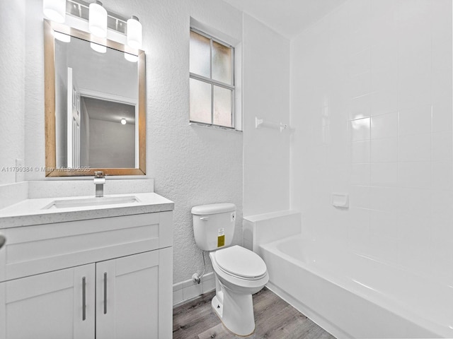 2482 SE 14th Ct, Homestead, FL 33035 - bathroom with wood finished floors, toilet, a textured wall, vanity, and baseboards