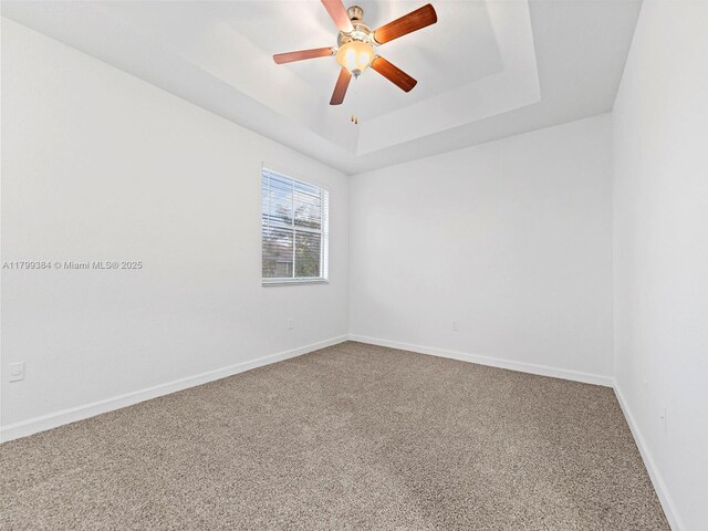 2482 SE 14th Ct, Homestead, FL 33035 - empty room featuring carpet, a tray ceiling, baseboards, and ceiling fan