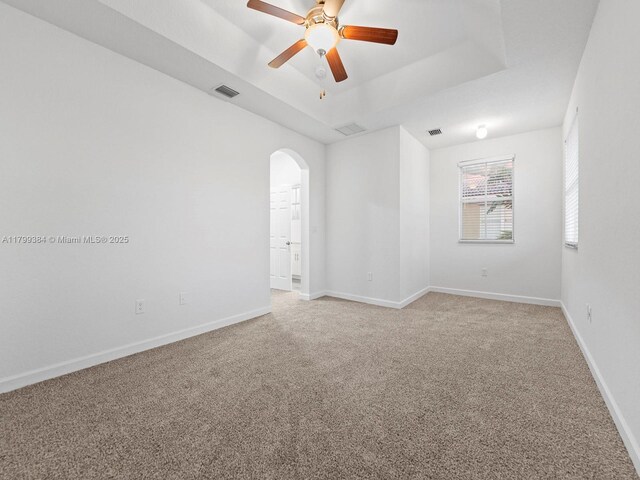 2482 SE 14th Ct, Homestead, FL 33035 - spare room featuring light colored carpet, arched walkways, a ceiling fan, and baseboards