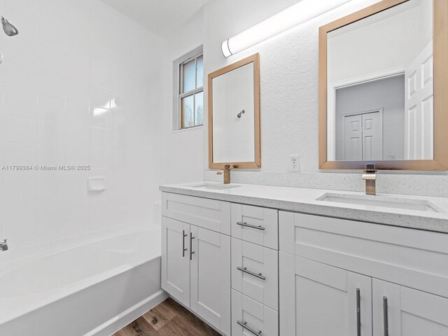 2482 SE 14th Ct, Homestead, FL 33035 - full bathroom featuring wood finished floors, double vanity, and bathing tub / shower combination