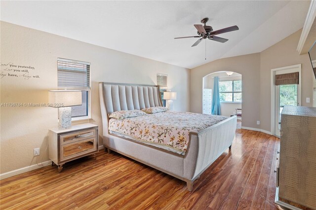 5514 NW W Lundy Cir, Port St Lucie, FL 34986 - bedroom featuring arched walkways, vaulted ceiling, wood finished floors, baseboards, and ceiling fan