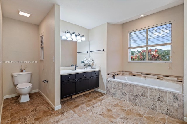 5514 NW W Lundy Cir, Port St Lucie, FL 34986 - bathroom featuring vanity, a bath, toilet, and baseboards
