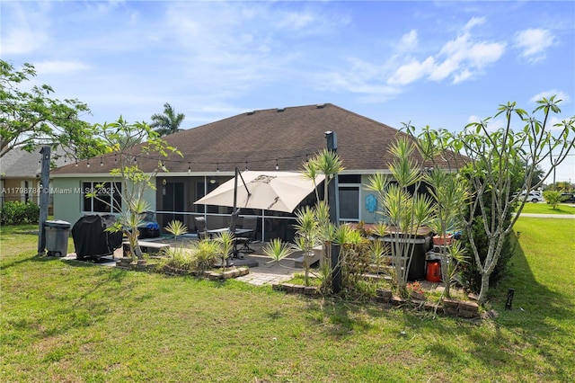 5514 NW W Lundy Cir, Port St Lucie, FL 34986 - rear view of house with a lawn, roof with shingles, and a patio area
