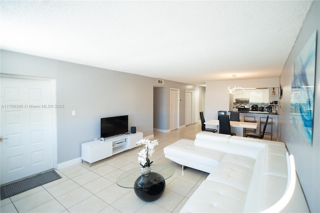 6950 Miami Gardens Dr Unit 2-502, Hialeah, FL 33015 - living room with light tile patterned flooring, baseboards, and a textured ceiling