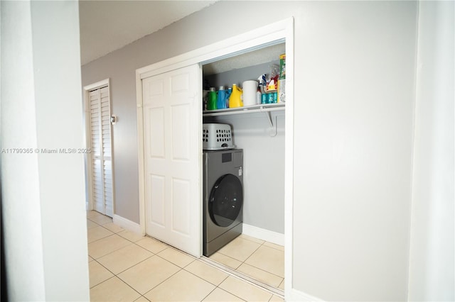 6950 Miami Gardens Dr Unit 2-502, Hialeah, FL 33015 - clothes washing area featuring washer / clothes dryer, light tile patterned floors, and baseboards