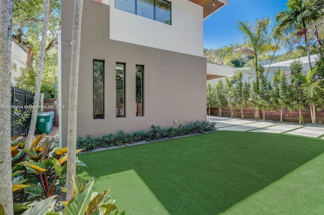 1780 Chucunantah Rd, Miami, FL 33133 - view of side of home with stucco siding and a patio